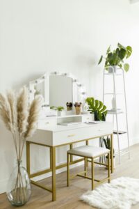 pexels-photo-8580762-8580762 A modern vanity table with plants and decor, showcasing minimalist home interior design style.